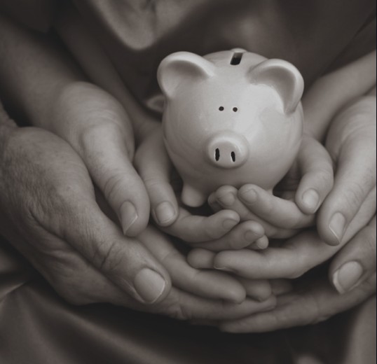 parent and child holding piggy bank